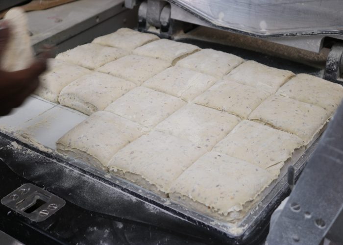 Découpe des pâtons de nos baguettes dans l'atelier de boulangerie de la Baguettine de Gruissan, à Gruissan